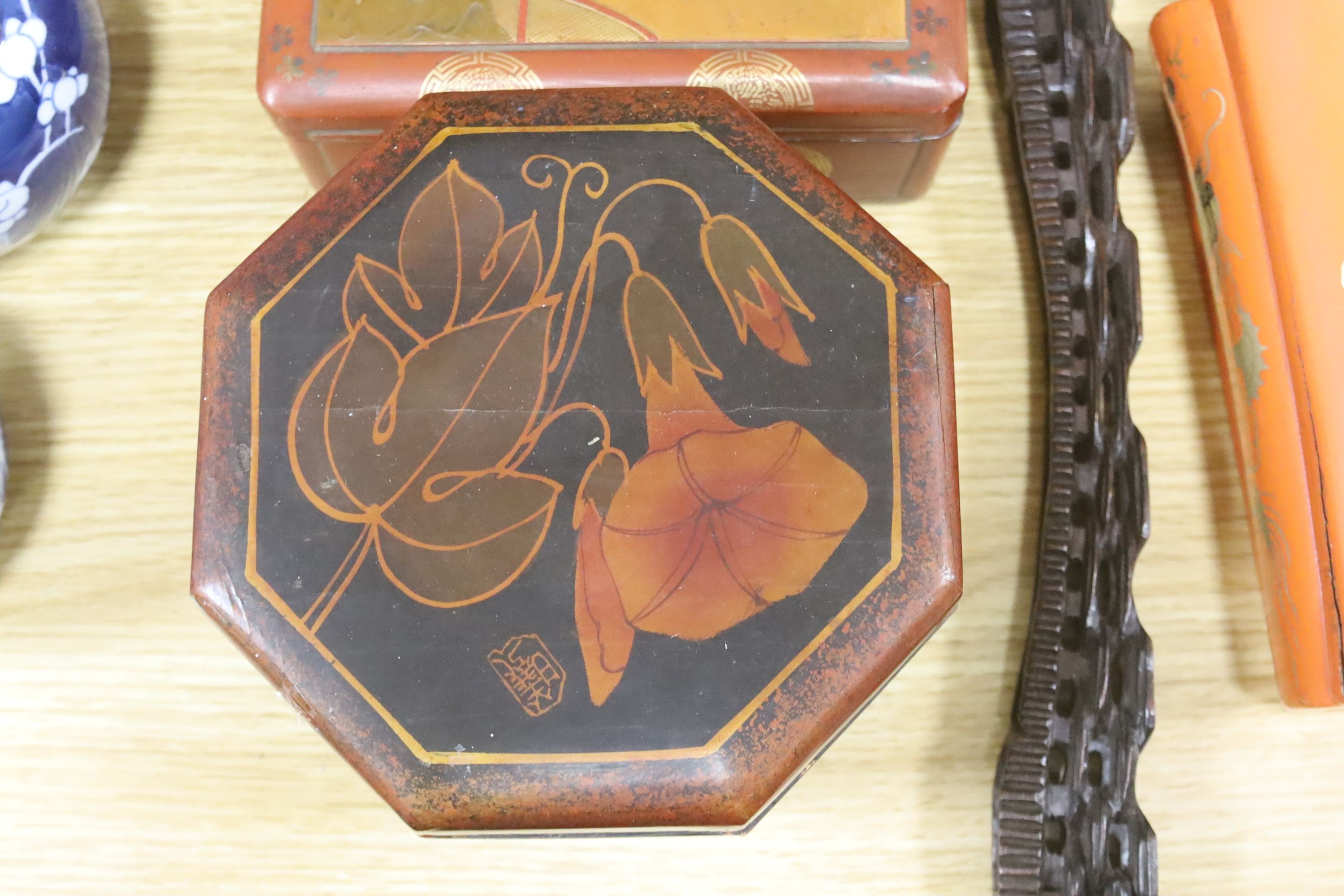 A group of Chinese or Japanese lacquer boxes and a wood stand